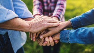 hands-of-small-girl-and-her-senior-grandparents-EKH9UTX.jpg